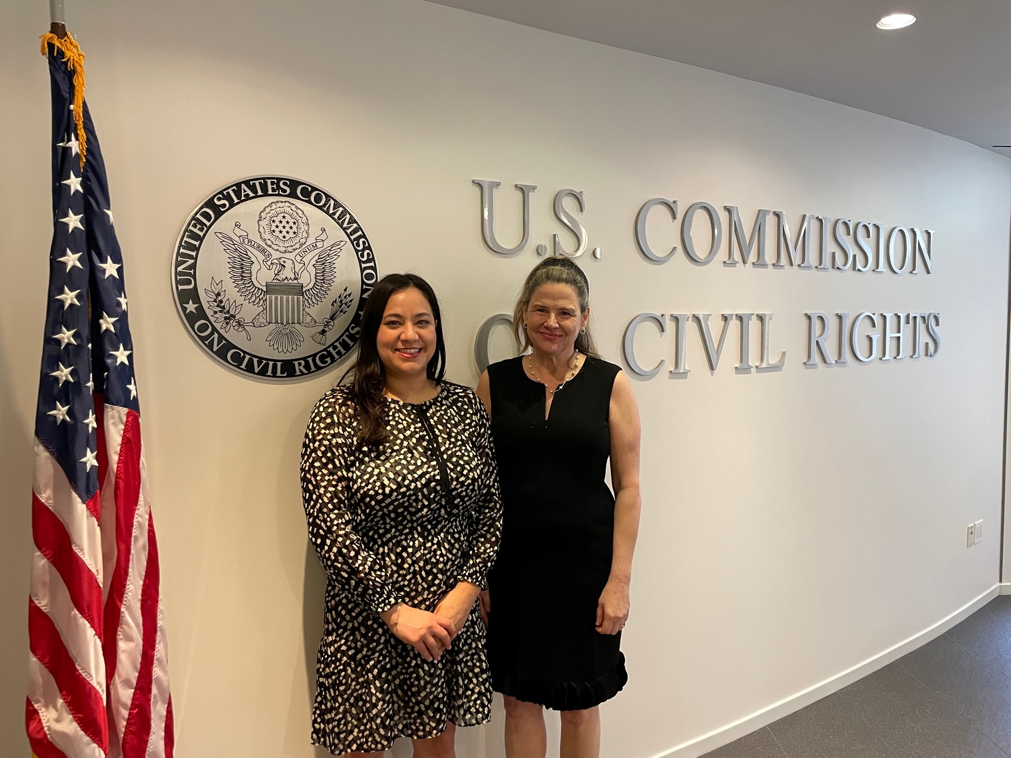Chair Rochelle Garza and Vice-Chair Victoria Nourse in front of the Commission on Civil Rights sign at their HQ Office in Washington D.C. after the July 21, 2023, Business Meeting